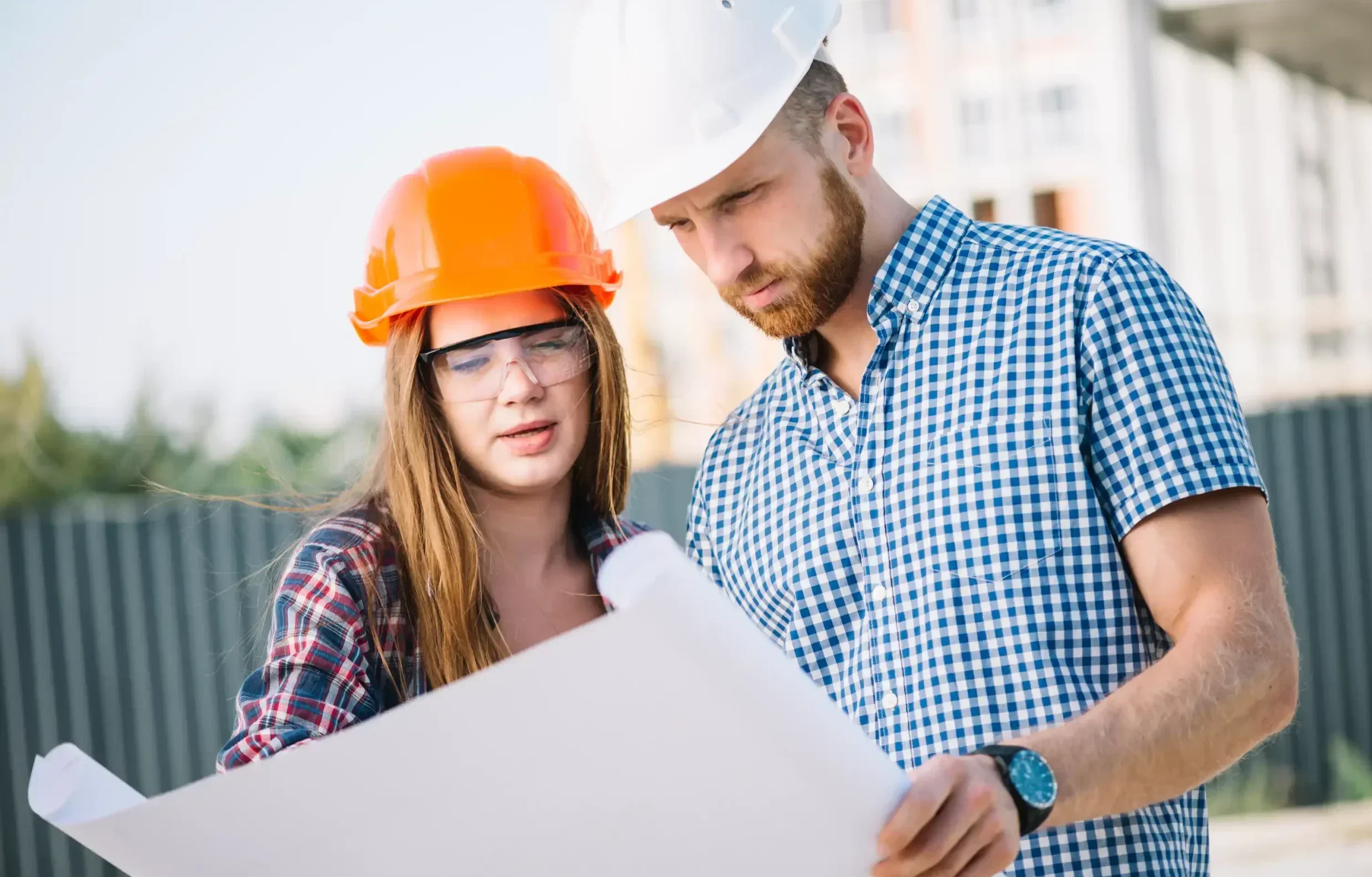 Man and woman holding plan - concrete contractors in Jackson MI